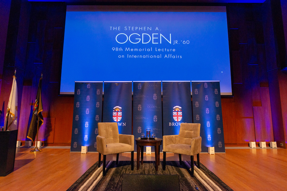 Two empty chairs sitting on a stage